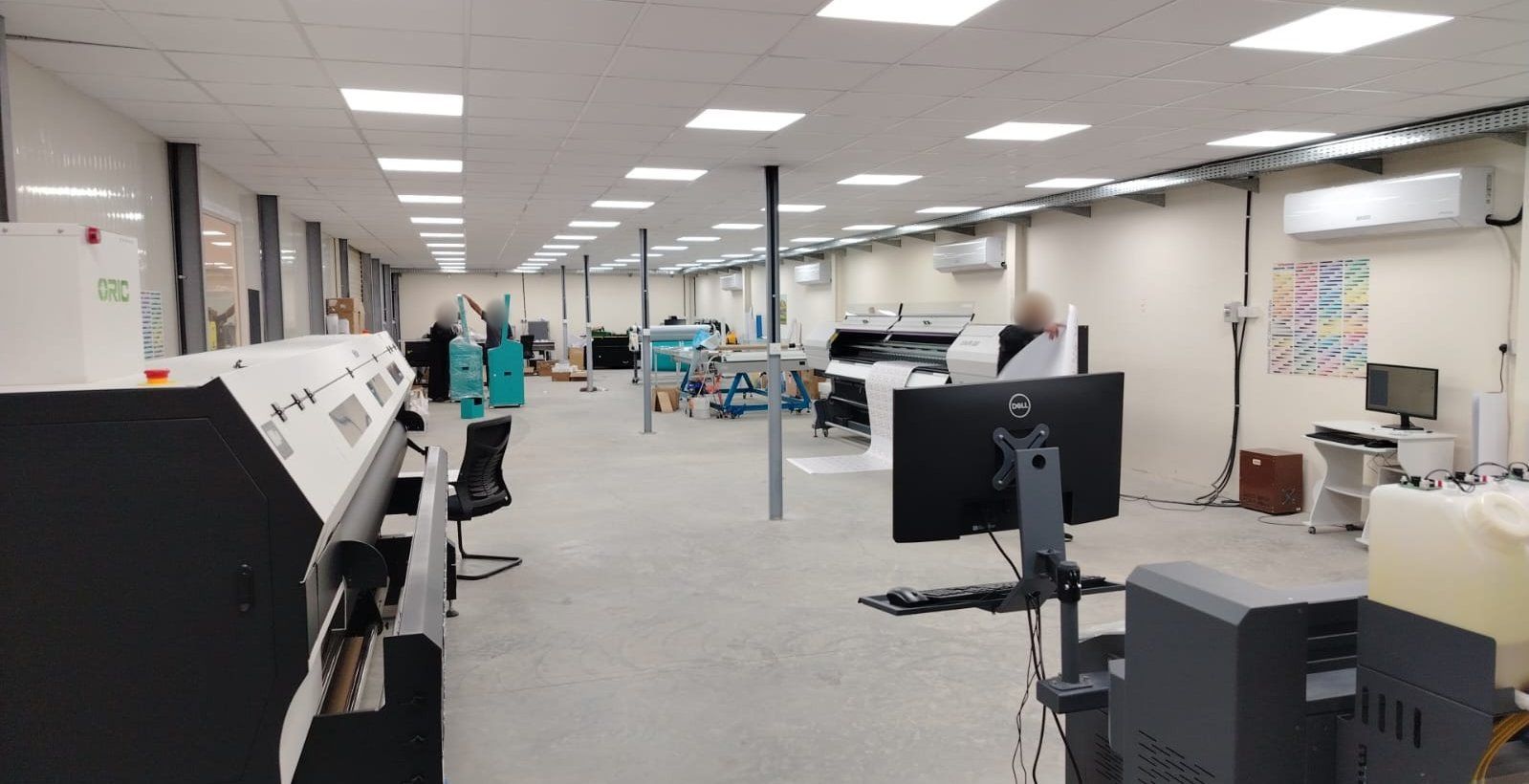 PROJECTA factory floor with in-house printing and production equipment