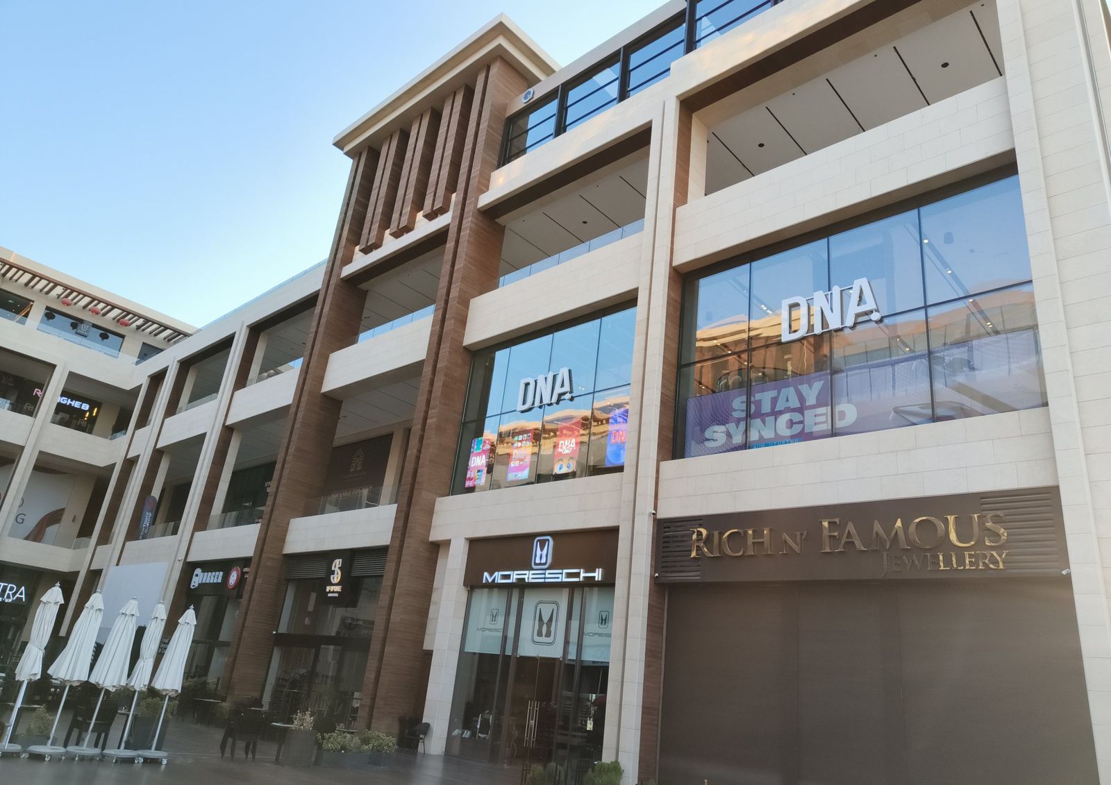 Multi-storey retail building with large-format facade graphics and illuminated signage